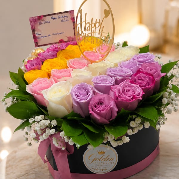 Round box arrangement of multicolored roses with a birthday topper