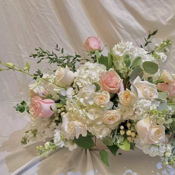 Blush and white floral arrangement with roses and hydrangeas