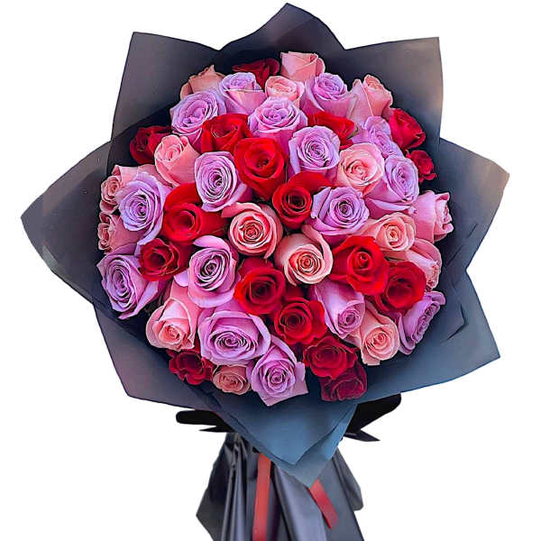 Bouquet of red, pink, and lavender roses wrapped in black paper