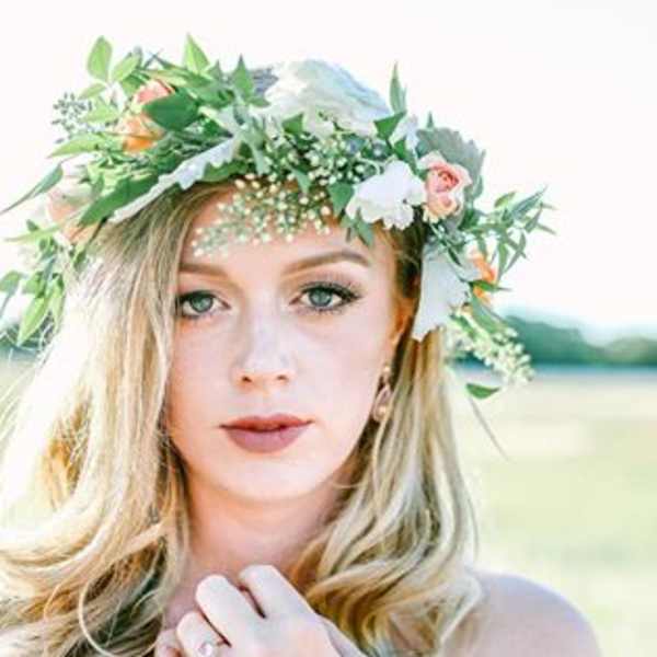 Woman wearing a floral crown with white and pink flowers