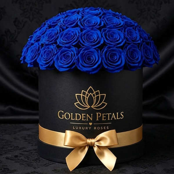 Blue roses arranged in a black round box with a gold ribbon