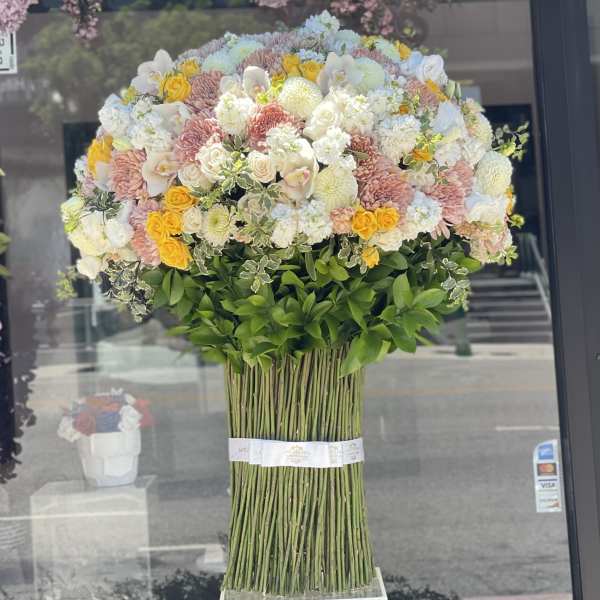 Large mixed bouquet of pastel flowers with a tall stem bundle