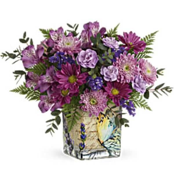 Purple mixed bouquet in a painted square vase