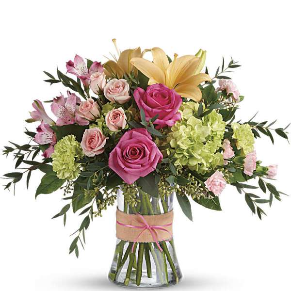 Pink and peach flower arrangement in a glass vase