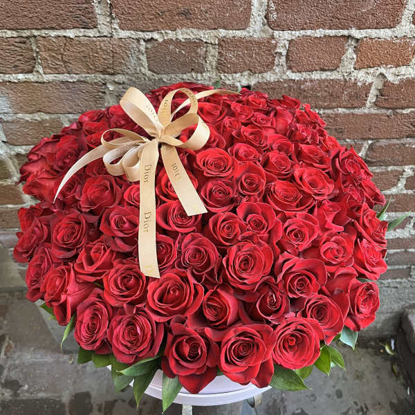 Large bouquet of red roses with a beige ribbon