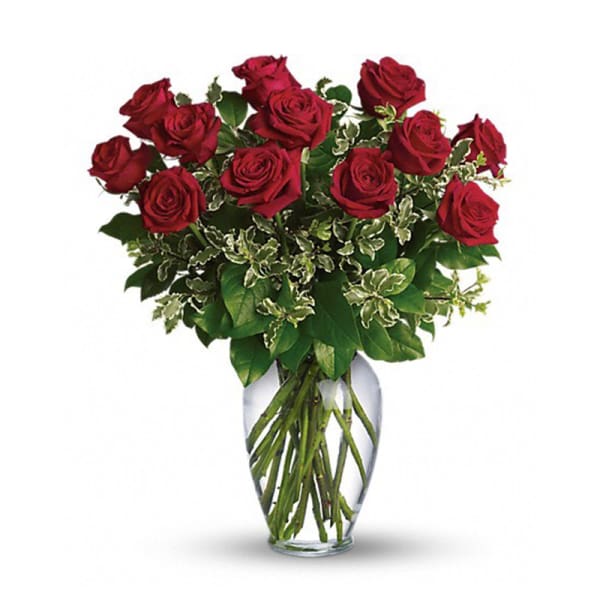 Red roses arranged in a clear glass vase