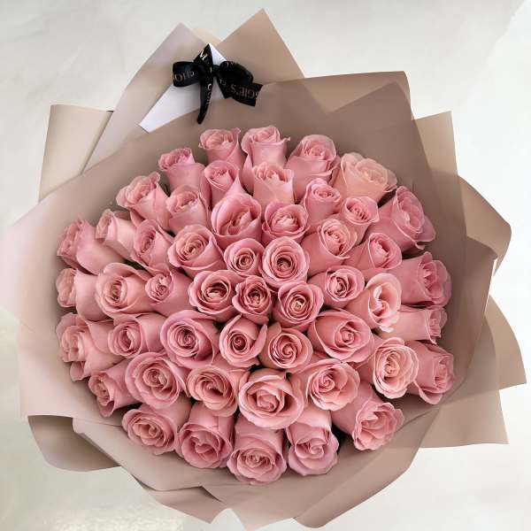 Bouquet of pink roses wrapped in blush paper