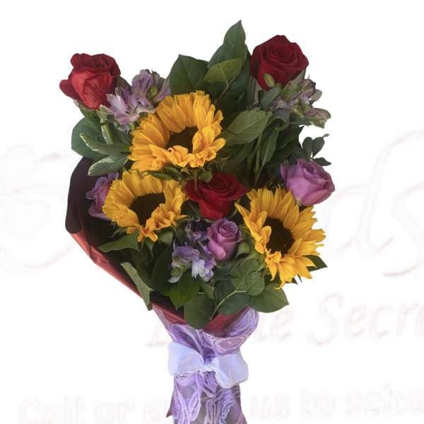 Bouquet of sunflowers, red roses, and purple flowers wrapped in lavender paper