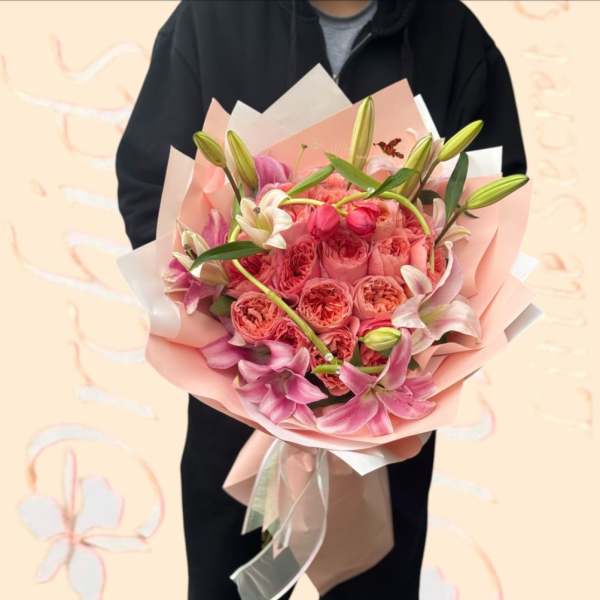 Pink bouquet of roses and lilies wrapped in pastel paper