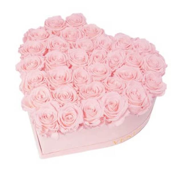 Heart-shaped box filled with pale pink roses