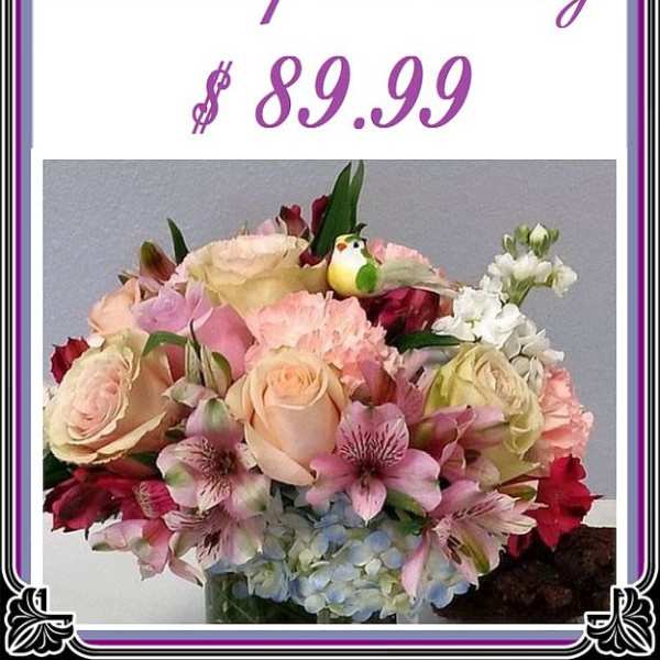 Mixed bouquet of roses, lilies, and hydrangeas in a vase