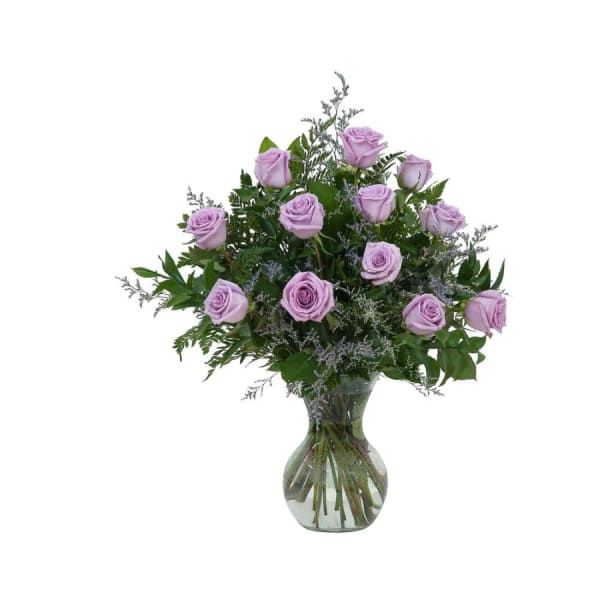 Lavender roses arranged in a clear glass vase