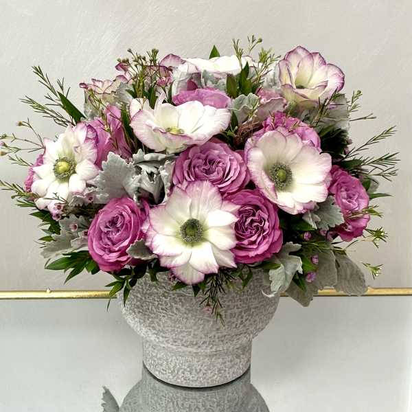 Pink and white roses with white anemones in a textured vase
