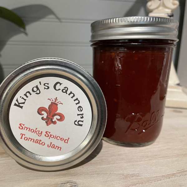 Two jars of smoky spiced tomato jam on a countertop