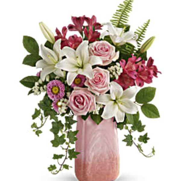Pink and white floral arrangement in a tall pink vase