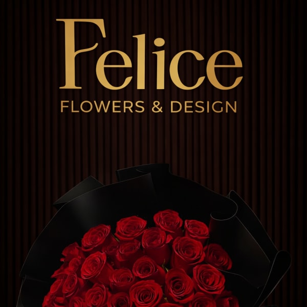 A large bouquet of red roses wrapped in black paper.