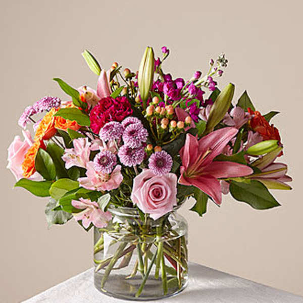 Mixed pink and purple bouquet in a clear glass vase