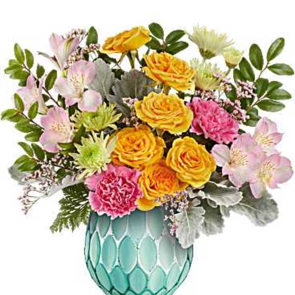 Bouquet of yellow roses, pink carnations, and pale alstroemeria in a turquoise vase