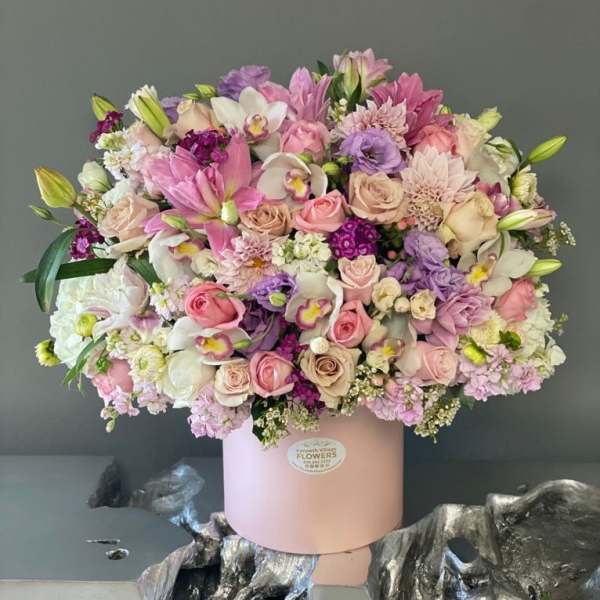 Large pastel bouquet in a pink hatbox with roses and lilies