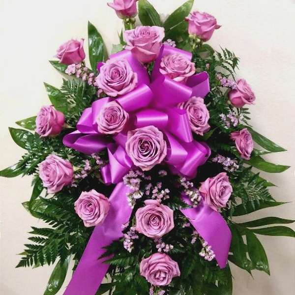 Pink rose spray with a large purple ribbon bow