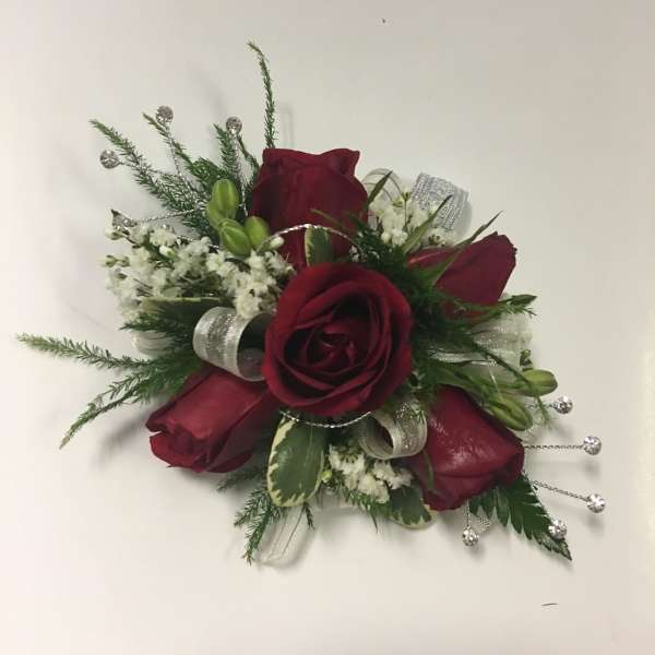 Red rose corsage with white filler and silver ribbon