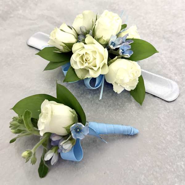 White rose corsage and boutonniere with blue ribbon accents