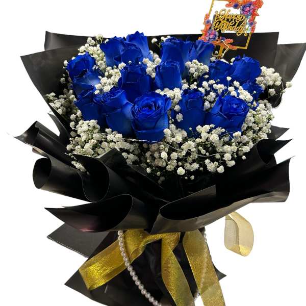 Bouquet of blue roses with baby's breath and a happy birthday topper