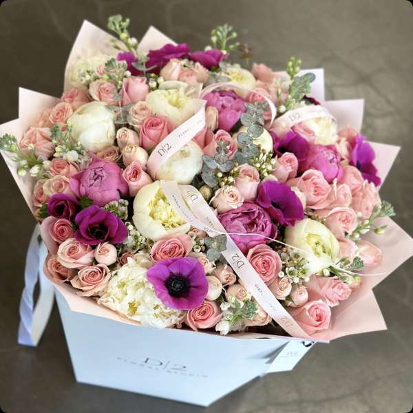 Large bouquet of pink and white flowers in a white box
