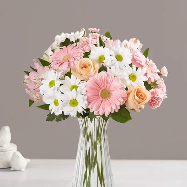 Pink and white mixed bouquet in a clear glass vase