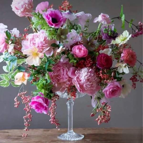 Large pink and white floral arrangement in a clear glass vase