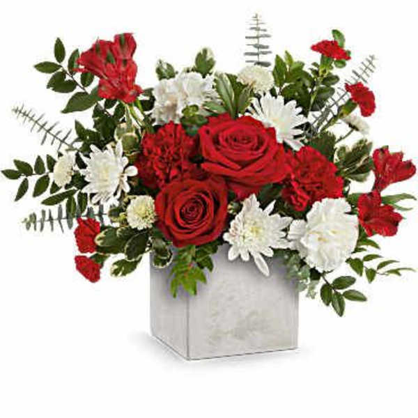 Red roses and white daisies in a square vase