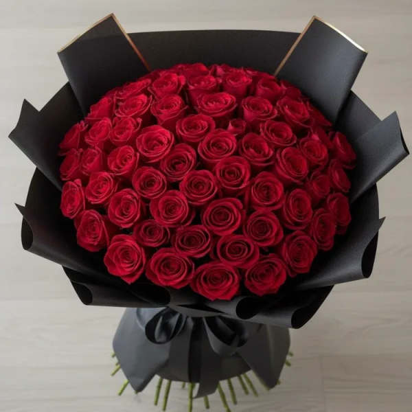 Bouquet of red roses wrapped in black paper