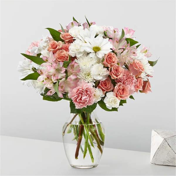 Pink and white mixed bouquet in a clear glass vase
