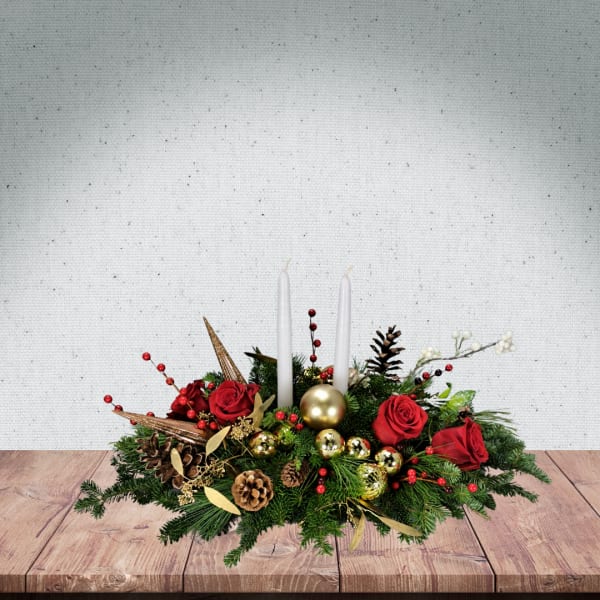 Christmas centerpiece with red roses, white candles, and gold ornaments
