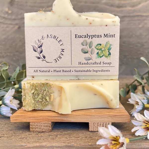 Two bars of eucalyptus mint handcrafted soap stacked on a wooden stand