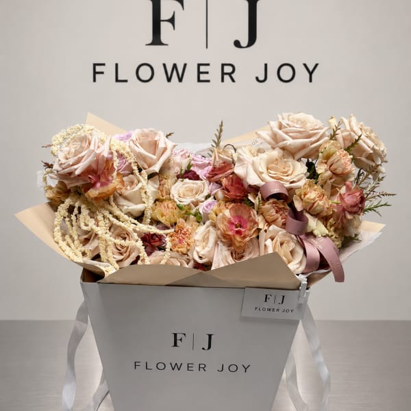 Bouquet of blush and cream roses in a white gift box