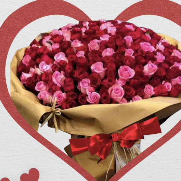 Large bouquet of red and pink roses wrapped in brown paper with a red bow