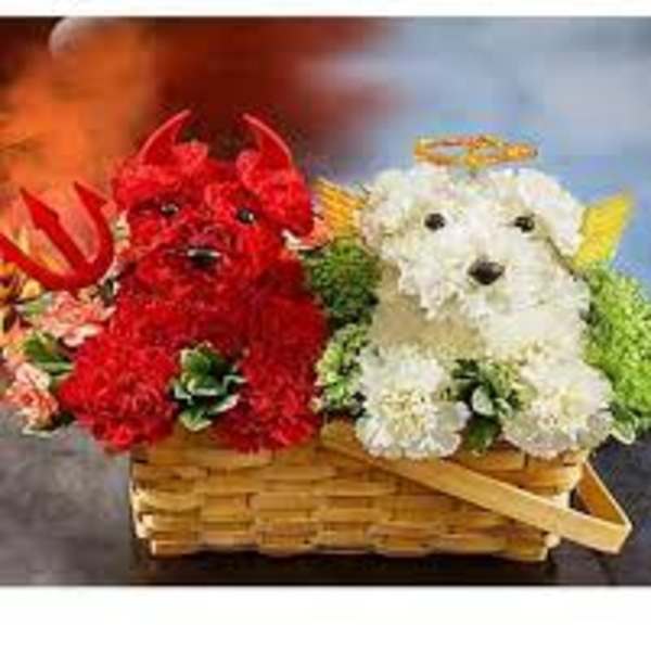 Two flower-covered dog figurines in a wicker basket
