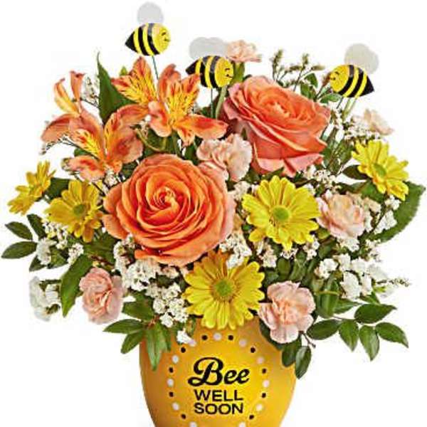 Orange and yellow flower arrangement in a bee-themed pot with bee picks