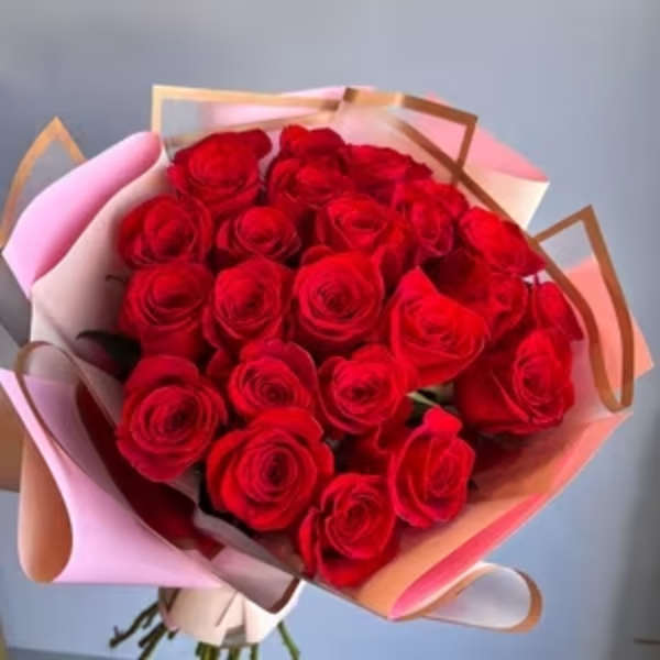 Bouquet of red roses wrapped in pink and peach paper