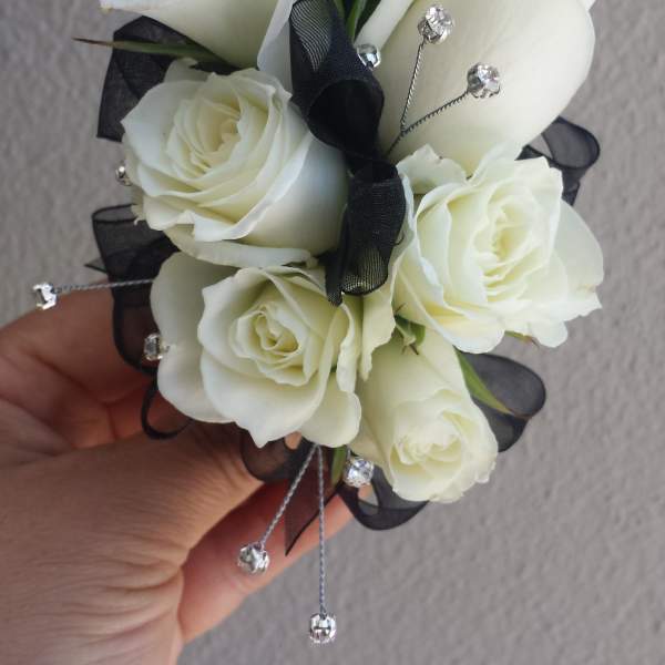 White rose corsage with black ribbon and silver accents