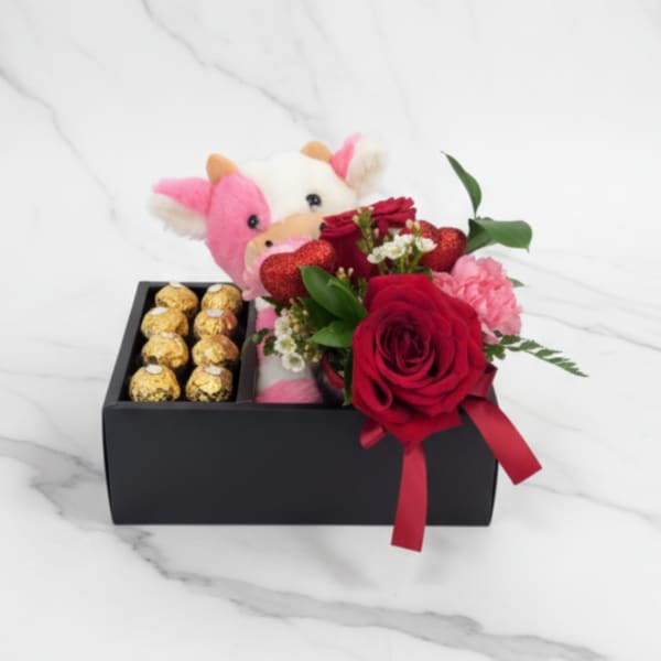 Gift box with a plush cow, red roses, and chocolates