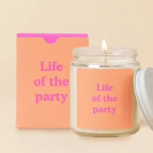 Glass candle jar with a peach label and matching box