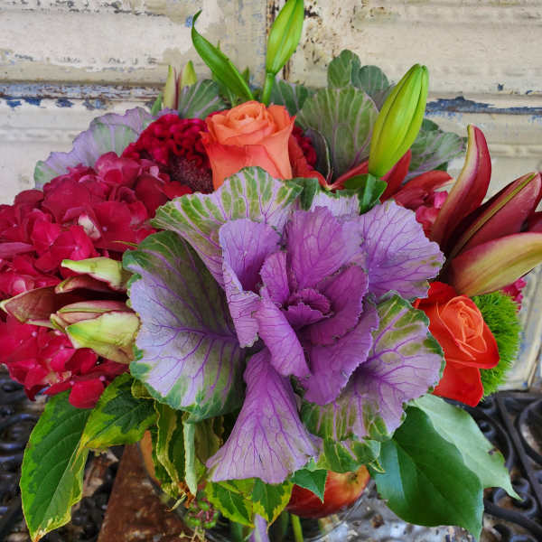 Bouquet with orange roses, lilies, hydrangea, and purple ornamental cabbage