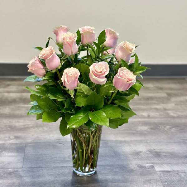 Pink roses arranged in a clear glass vase
