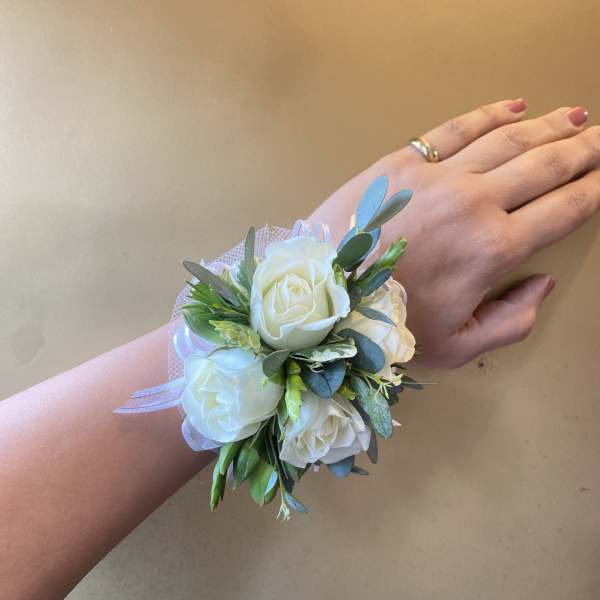 White rose wrist corsage with ribbon and greenery