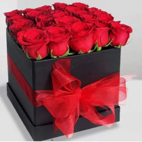 Red roses arranged in a black square box with a red ribbon bow