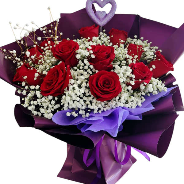 Bouquet of red roses with white baby's breath in purple wrapping