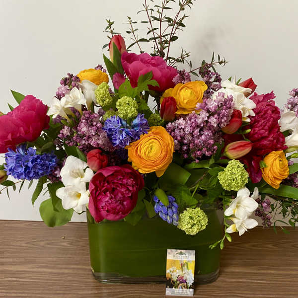 Colorful mixed bouquet in a green glass vase