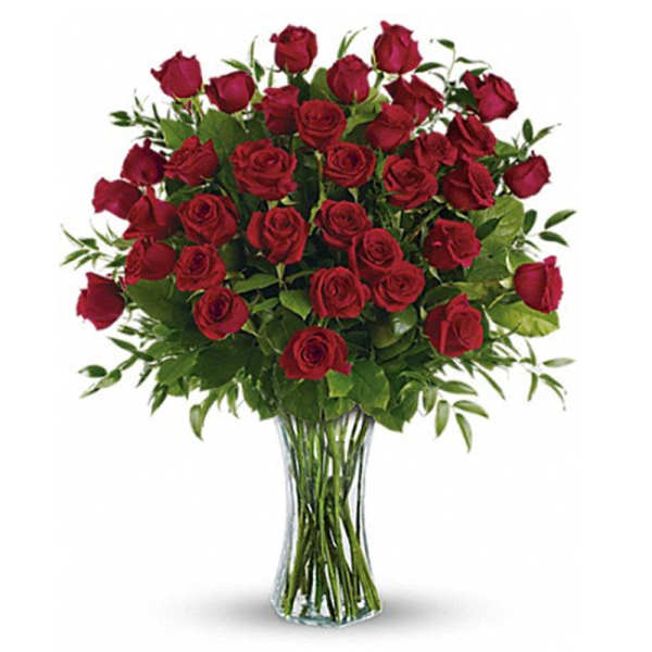 A bouquet of red roses in a clear glass vase